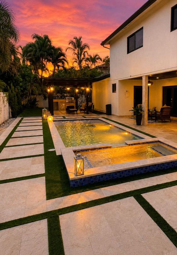Custom pool, spa, pergola and outdoor kitchen built by DiLusso Construction in Miami